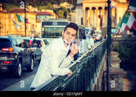 Handsome Young Man Leaning on City Bridge Handrail Stock Photo