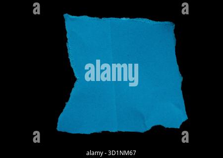 Ripped blue paper torn edges isolated on black background, paper tear Stock Photo