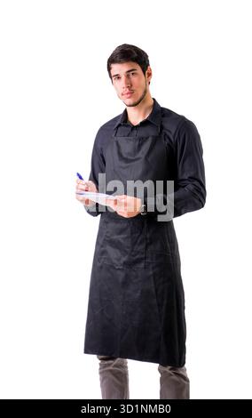 Young chef or waiter wearing black apron isolated Stock Photo