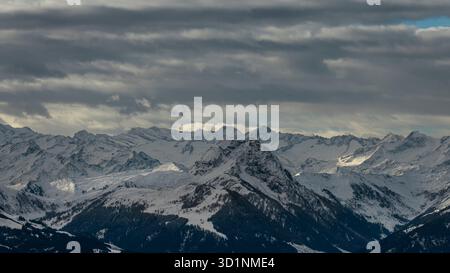 The Kitzbüheler Horn in Tirol, Austria, after the first snowfall of the season. Dramatic winter clouds sweep across the alpine ridge, revealing crisp Stock Photo