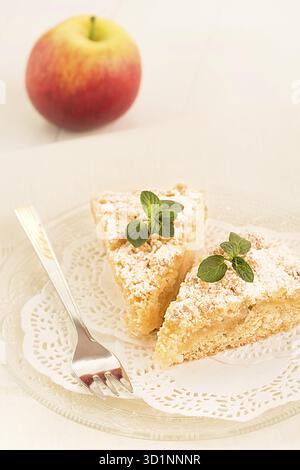Two pieces of freshly baked apple crumble cake are lying on a plate Stock Photo
