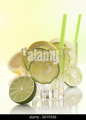 Cocktail with lime, lemon slices and ice cube cubes Stock Photo
