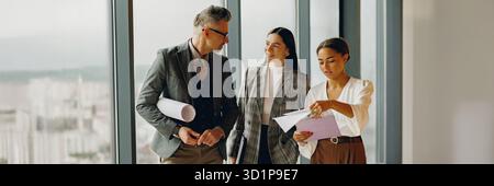 Business Team Engaging in Collaborative Discussions Within a Modern Office Space Environment Stock Photo