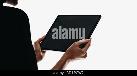 Person holding a tablet with a blank screen, isolated on a white background, emphasizing technology, connectivity, and creativity. Digital devices, mo Stock Photo
