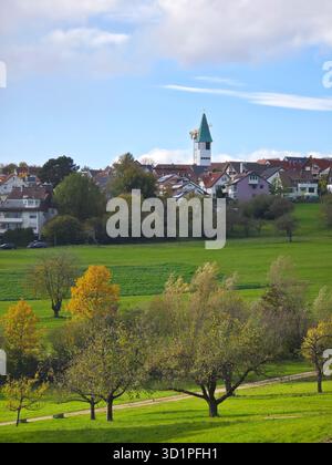 Germany, Ostfildern kemnat village houses church steeple skyline, green nature scenery view above tree tops in autumn season at sunset Stock Photo
