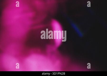 Abstract Pink Magenta and Black Grainy Texture Background with Subtle Spotlight defocused effect. High quality. Stock Photo