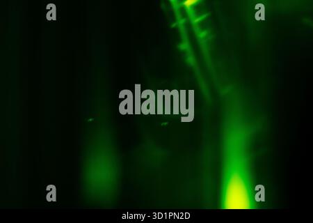Blurred green magical light effect on black background. Stock Photo