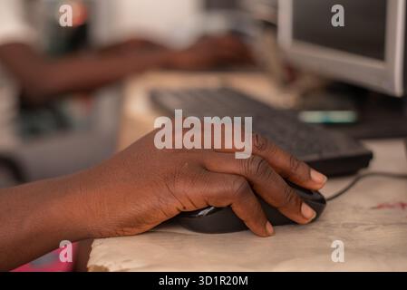 female hand holding computer mouse in office. Stock Photo