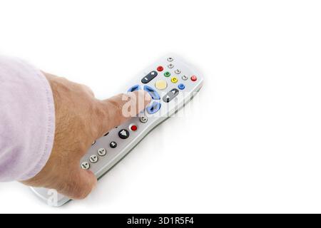 Male hand pressing silver remote control on a white background with copy-space Stock Photo
