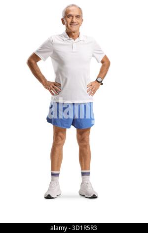 Elderly man in blue shorts and white t-shirt posing isolated on white background Stock Photo