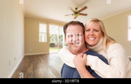 Happy Caucasian Young Adult Couple In Empty Room of House Stock Photo