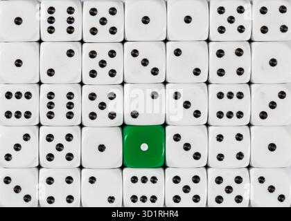Background of random ordered white dices with one green cube Stock Photo