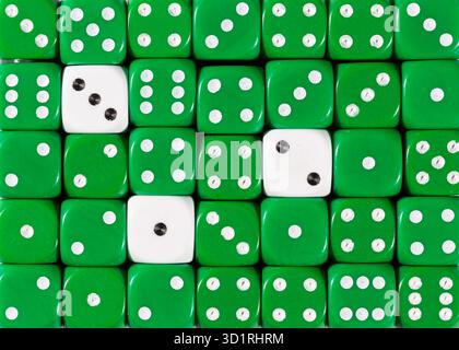 Background of random ordered green dices with three white cubes Stock Photo