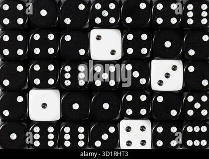 Background of random ordered black dices with four white cubes Stock Photo