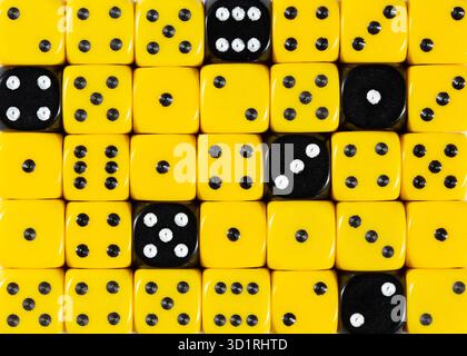 Background of random ordered yellow dices with six black cubes Stock Photo