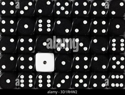 Background of random ordered black dices with one white cube Stock Photo
