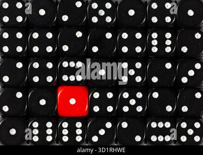 Background of random ordered black dices with one red cube Stock Photo