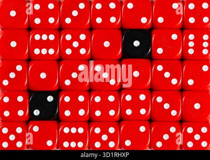 Background of random ordered red dices with two black cubes Stock Photo