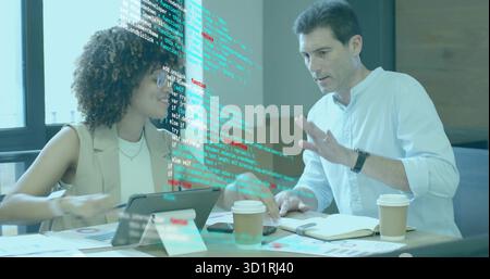 Reviewing software two software professionals collaborating in office, with tablet and charts Stock Photo