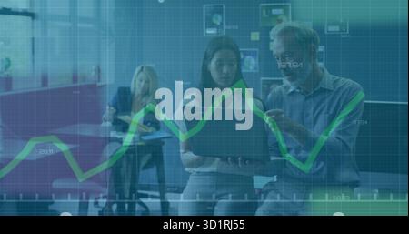 Two professionals in business attire collaborating in office lounge with laptop showing line chart Stock Photo