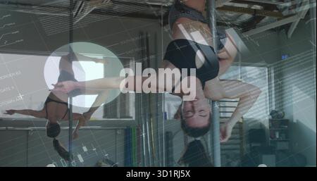 Balancing chrome pole fitness woman holding inverted hold in studio, with mirrored wall, props Stock Photo