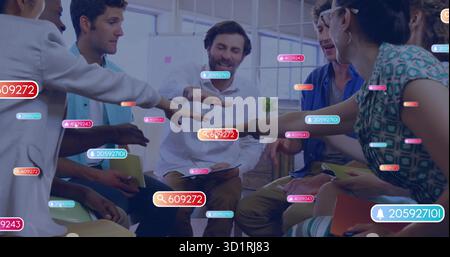 Seven professionals joining hands in loft office, with chairs and digital overlay tags Stock Photo