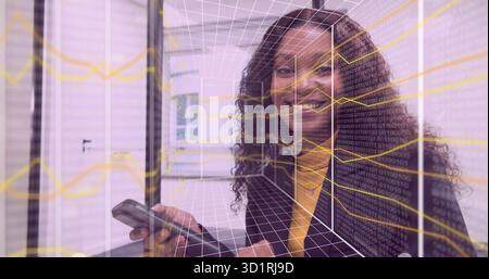 Smiling woman in formal attire using smartphone in server room with cabinets showing digital grid Stock Photo