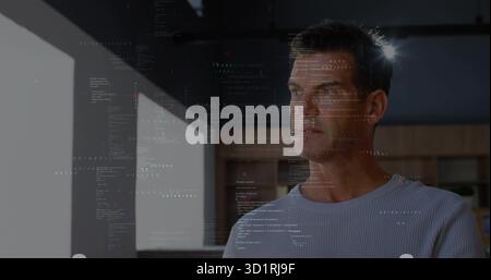 Displaying software developer gazing through office window with cabinets, overlaying code patterns Stock Photo