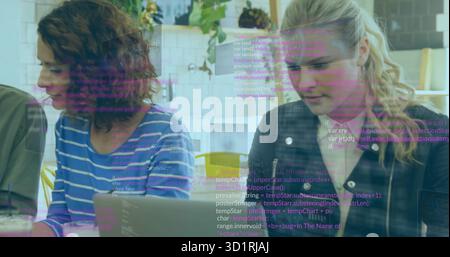 Collaborating developers typing code on laptops in office lounge, with coffee mug and code overlay Stock Photo