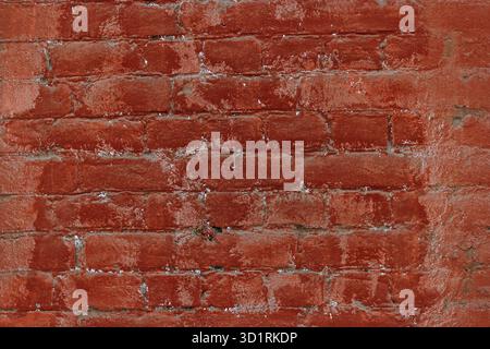 Old red brick wall painted in two different tones Stock Photo