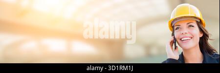 Banner With Female Contractor In Hard Hat Using Cell Phone Stock Photo