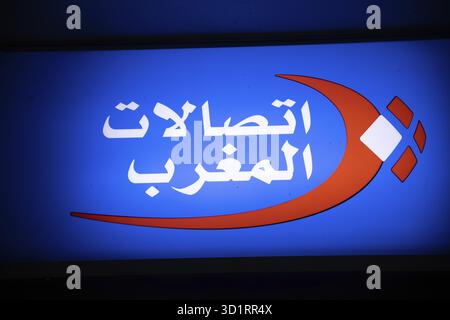 Marrakesch, Marrakesch-Safi - Morocco - 08-14-2024: A glowing company sign with Arabic text on a blue background, featuring orange and white elements Stock Photo
