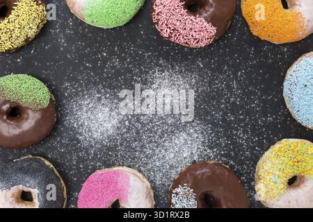 Colorful donuts on stone table. Top view with copy space Stock Photo