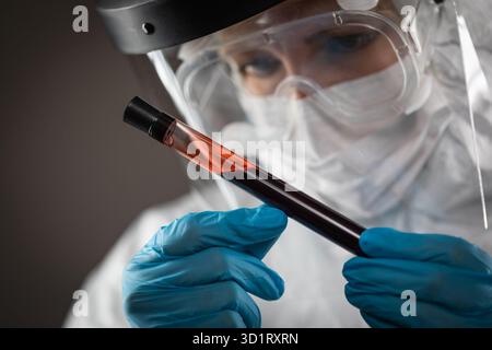 Female Lab Worker Holds Test Tube of Blood For Testing Stock Photo