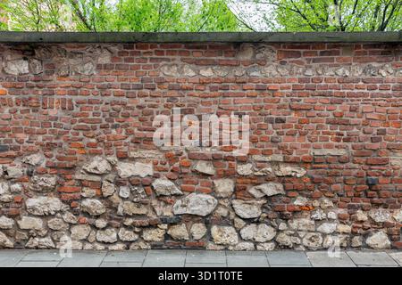 Background old brick wall with small and big stones Stock Photo