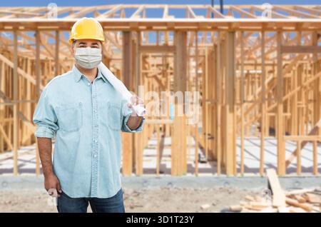 Male Contractor In Hard Hat Wearing Medical Face Mask During Coronavirus Pandemic At Construction Site Stock Photo