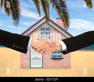 Closeup shot of a two businesspeople shaking hands a beach house background concept of buying property Stock Photo