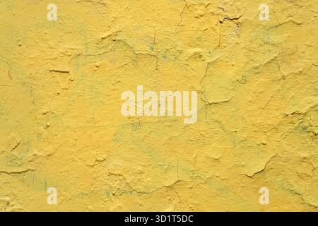 Old yellow grunge wall with cracked paint. High resolution vintage background. Stock Photo