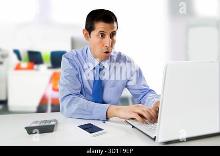 businessman working at the laptop and unimpressed by the screen information Stock Photo