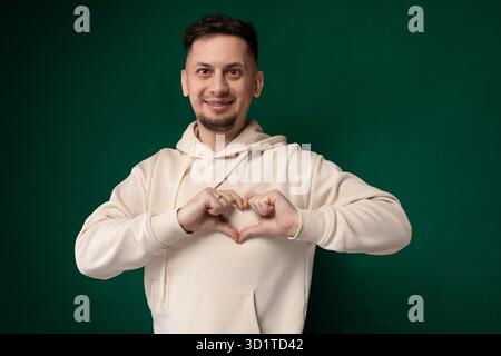 Man Making Heart Gesture With His Hands Stock Photo