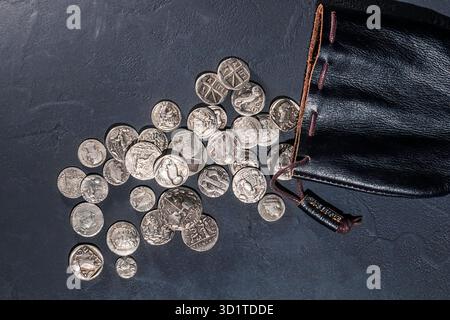 Leather pouch full of ancient silver coins Stock Photo