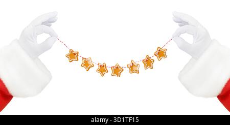 Christmas Santa Claus hands holding or gives gingerbread cookie star garland on red and white twine isolated on white background with clipping path. D Stock Photo