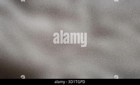 This image features a textured gray background with a grainy appearance and soft, blurred highlights Stock Photo