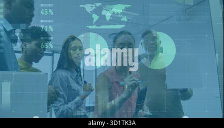 Five professionals analyzing charts and world map on office touchscreen, with tablets stylus pens Stock Photo