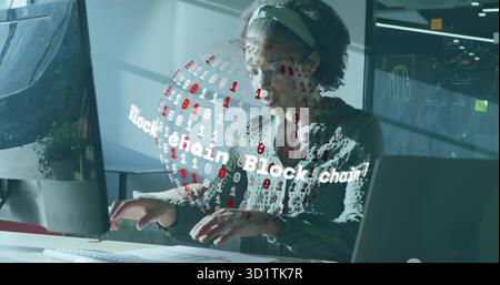 Typing software engineer at modern office desk with holographic blockchain projection and laptop Stock Photo