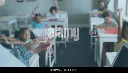 Pointing teacher's hand interacting with hexagonal icons in classroom, with students raising hands Stock Photo