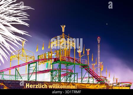 Cranger fair with colorfully illuminated rides and fireworks at night, Herne, Ruhr area, Germany Stock Photo