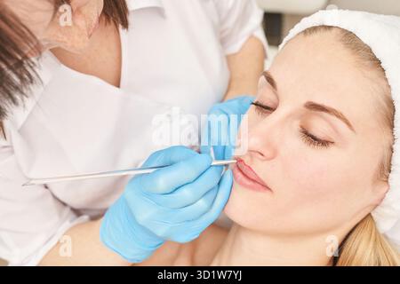 Permanent makeup. Beauty spa procedure. young woman. Face tattoo Stock Photo