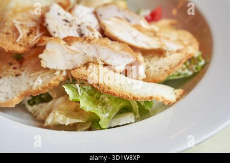 Caesar salad plate. Health food at cafe. Bread crouton, chicken, tomato, cheese Stock Photo