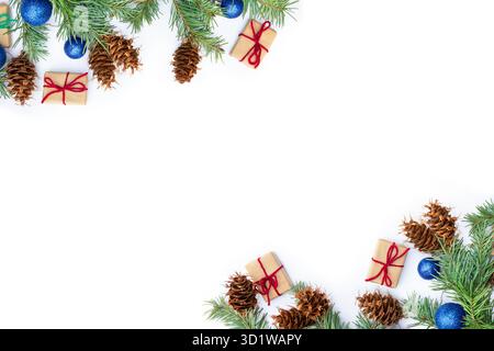 Top view flat lay of pine tree (Pseudotsuga menziesii) branches and cones, blue balls, boxes gift arranged on a white background with copy space Stock Photo